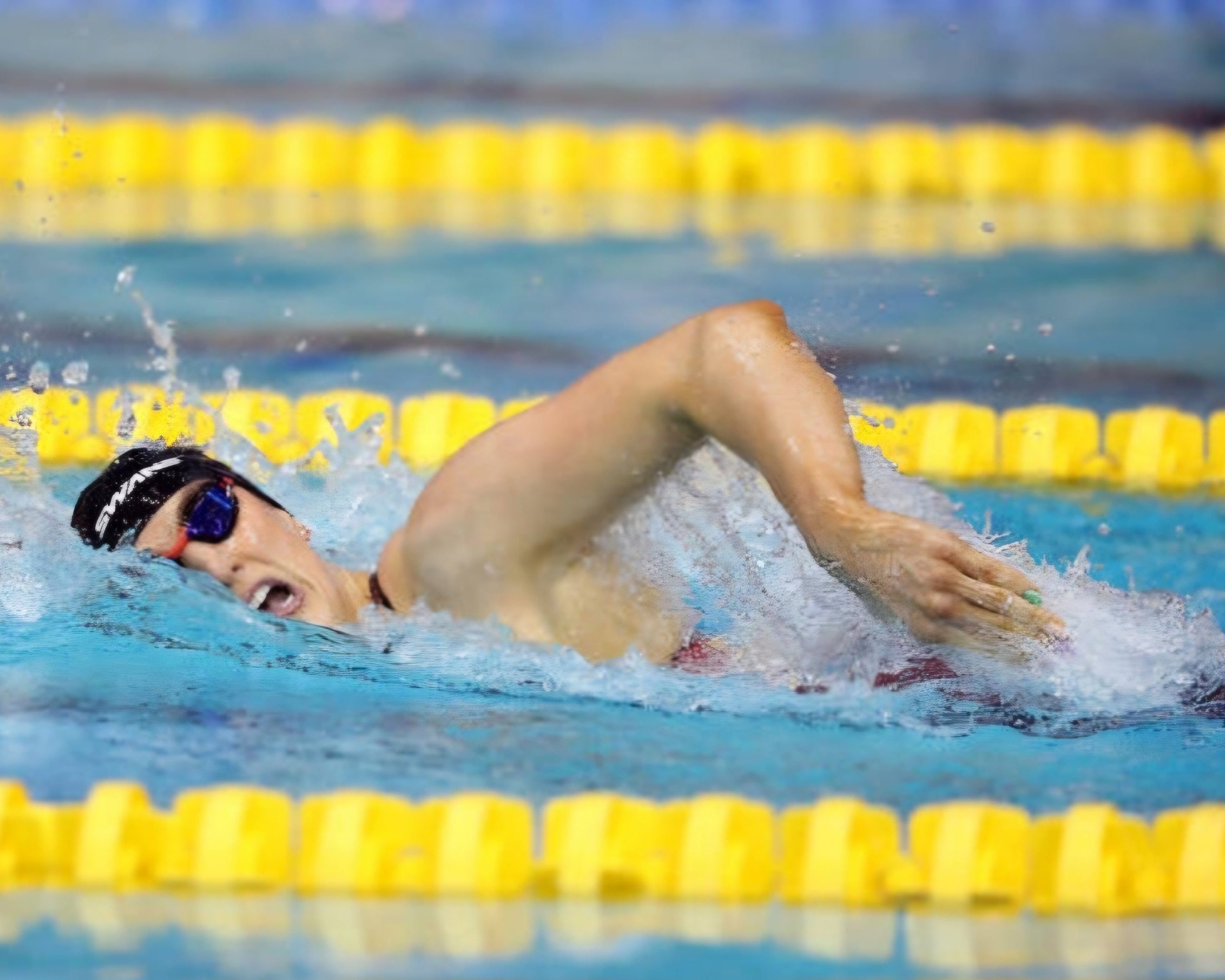 Bethany Firth, Parathlete swimming in a pool with yellow lane dividers